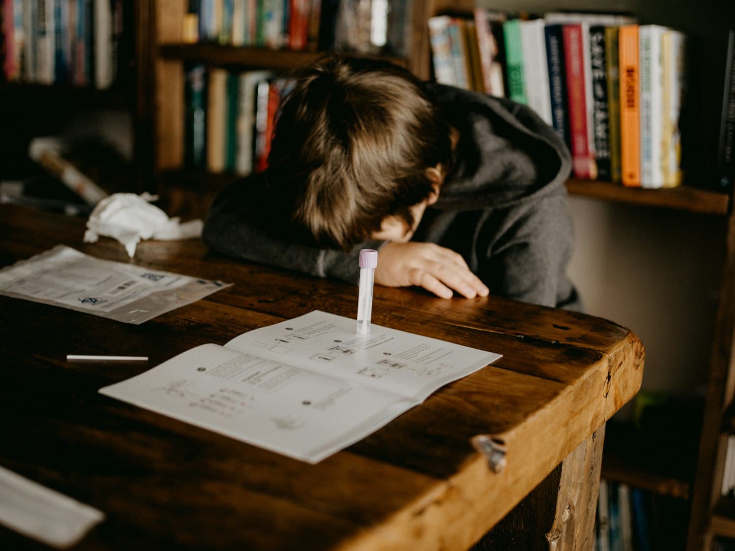 A student exhausted and overwhelmed at their desk